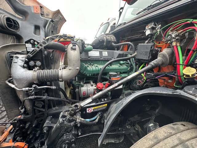 Mechanic performing emergency truck repair and semi-truck air cooling system service in Hiram.